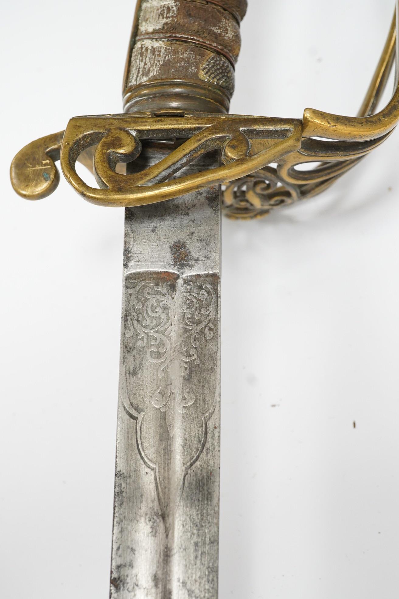 A Victorian 1845 pattern infantry officer’s sword, with regulation blade and brass hilt with folding side guard. Condition - fair, well worn over all.